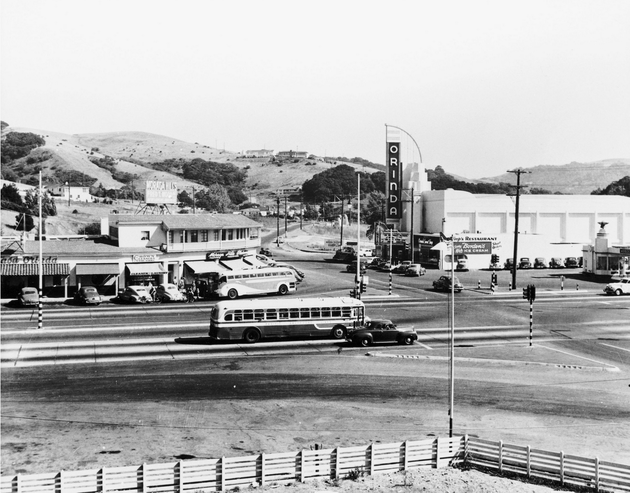 Orinda Crossroads, circa 1949. Oakland-bound bus in foreground. Orinda Theater, Casa Orinda restaurant, Crown Cleaners, Moraga Hills Pharmacy, Orinda Sweet Shop, Flying-A gas station. Traffic lights were installed in 1948.